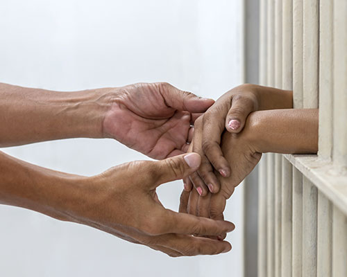 Holidng Hands Through Bars
